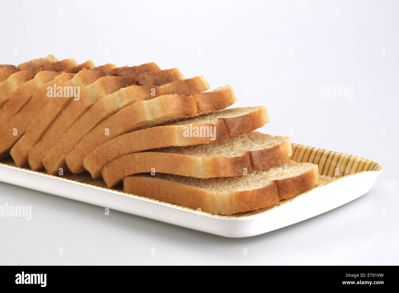 Sliced brown bread on white background Stock Photo