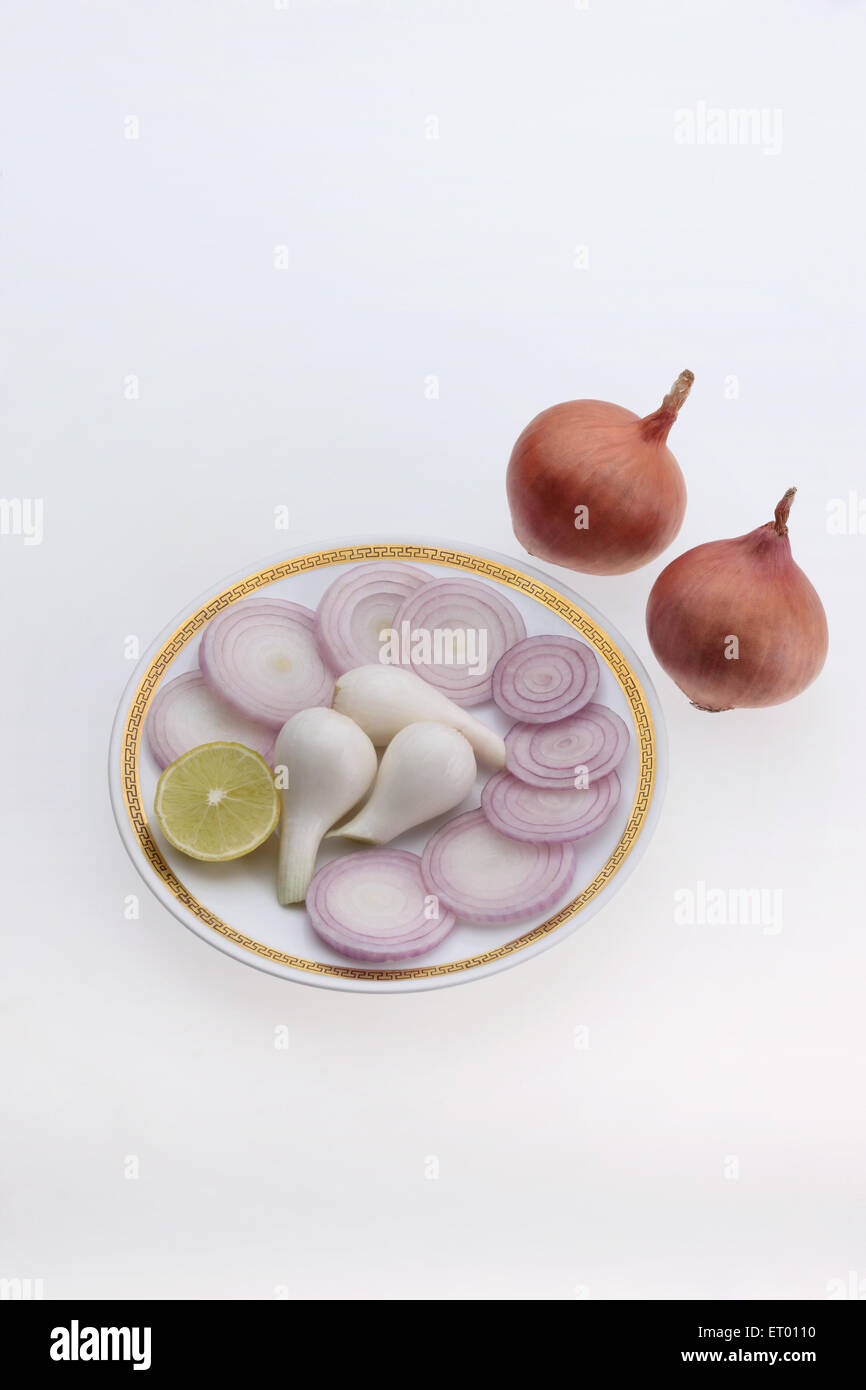 Slice of onions Latin Allium Cepa on a plate ; used as a vegetables and