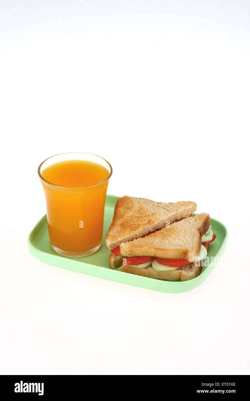 Vegetable bread sandwich with a glass of mango juice Stock Photo