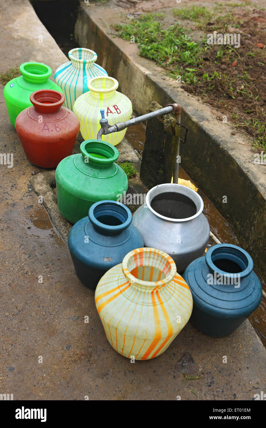 Plastic containers queue for water , Thekkady , Kerala , India Stock Photo