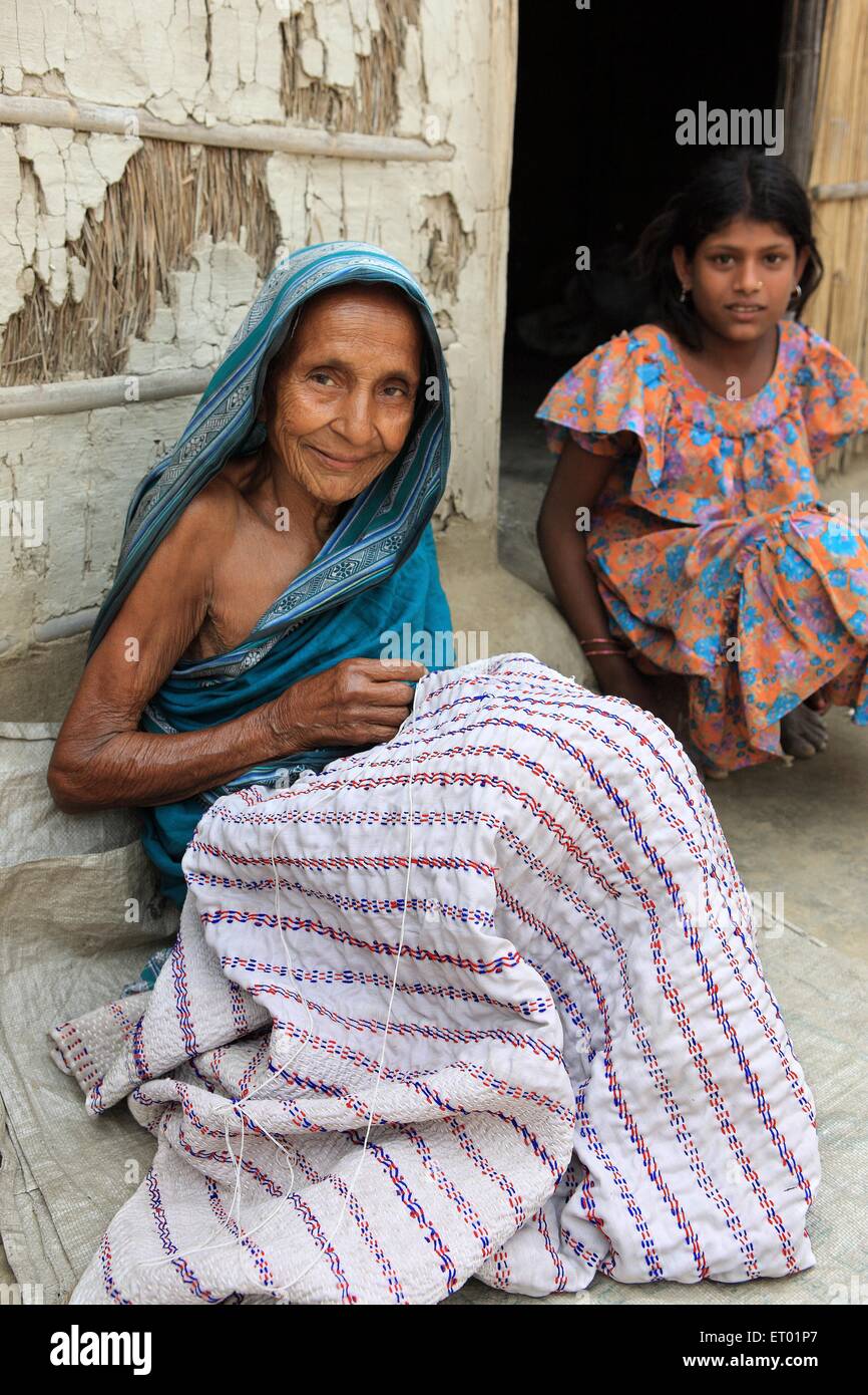 Old lady stitching  ; Assam  ; India NOMR Stock Photo