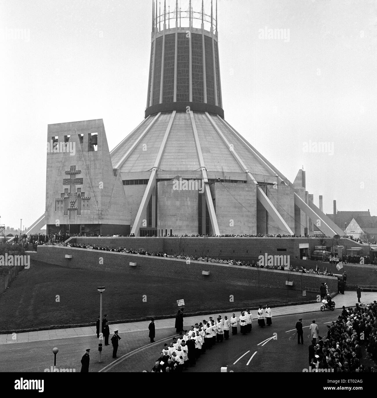 Crowds follow the Knights of St Gregory as the procession moves off in Liverpool, Merseyside to mark the opening of the new Liverpool Metropolitan Cathedral (also know as Metropolitan Cathedral of Christ the King). 16th May 1967. Stock Photo