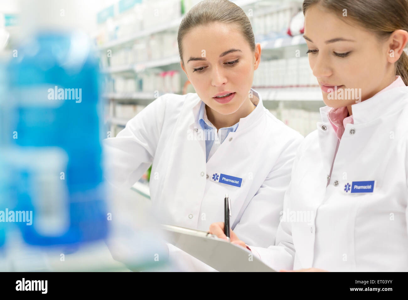 Pharmacists taking inventory in pharmacy Stock Photo