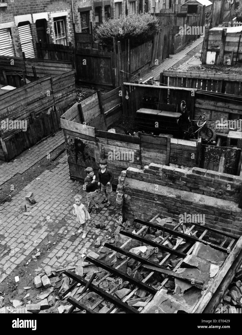 Slum housing in Birmingham. June 1967 Children play amongst the wreckage and shattered houses in the terrace at the back of 64 Anderton Street in Ladywood. June 1967. Stock Photo