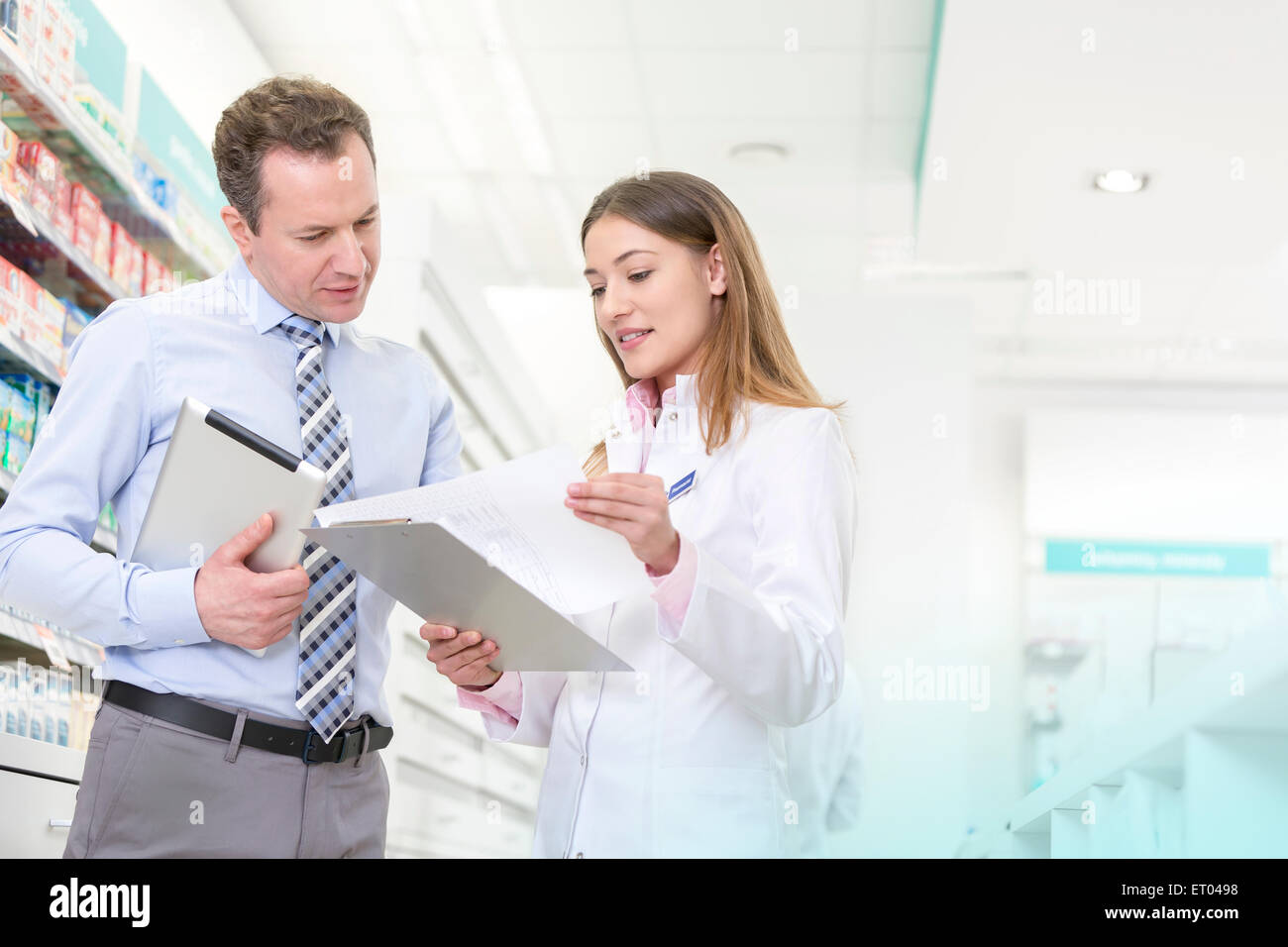 Pharmacist and manager reviewing paperwork in pharmacy Stock Photo
