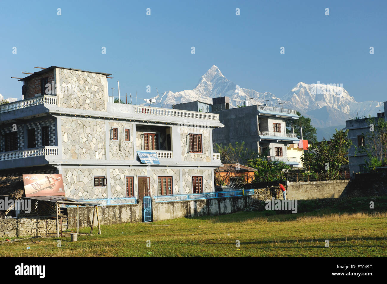 Houses and Machhapuchchhre , Fishtail mountain , snow peaks , Pokhara , Nepal , Federal Democratic Republic of Nepal , South Asia , Asia Stock Photo