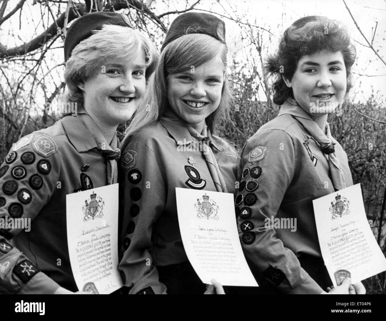 These three Norton school-girls who have been presented with their Queen's Guide awards are merely following in their families' footsteps.  Elisabeth Smith (left) for instance, already has two sisters who are, while Lynne Critchley (centre) has a Queen's Guide for a mother and a Queen's Scout for a father. Jennifer King too has a sister who is, and two brothers who are scouts. 2nd April 1984. Stock Photo