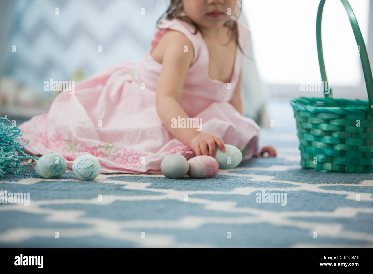 Girl in pink dress with Easter eggs Stock Photo