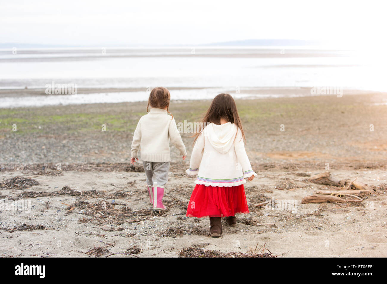 Girls walking on beach Stock Photo