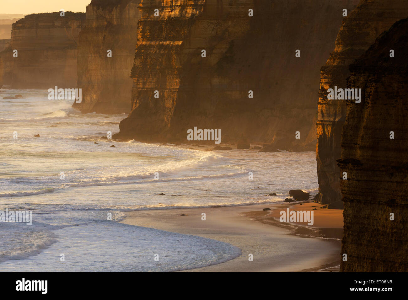 Rugged sandstone cliffs and sandy beach near Port Campbell, Great Ocean Road, Victoria, Australia Stock Photo