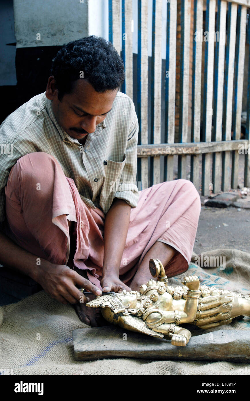 Man making bronze sculpture ; Irinjalakuda ; Kerala ; India NO MR Stock