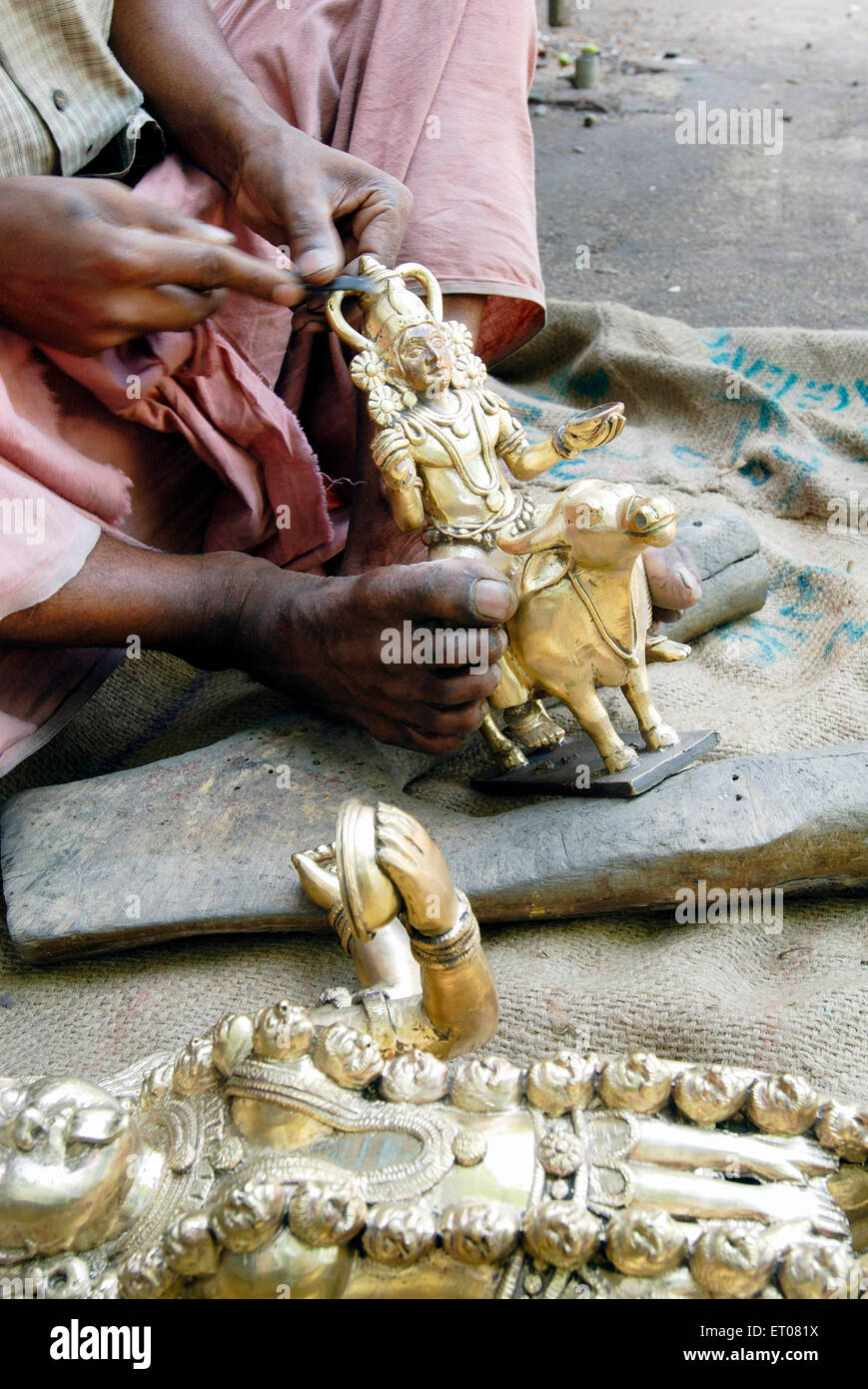 Man making bronze sculpture ; Irinjalakuda ; Kerala ; India Stock Photo