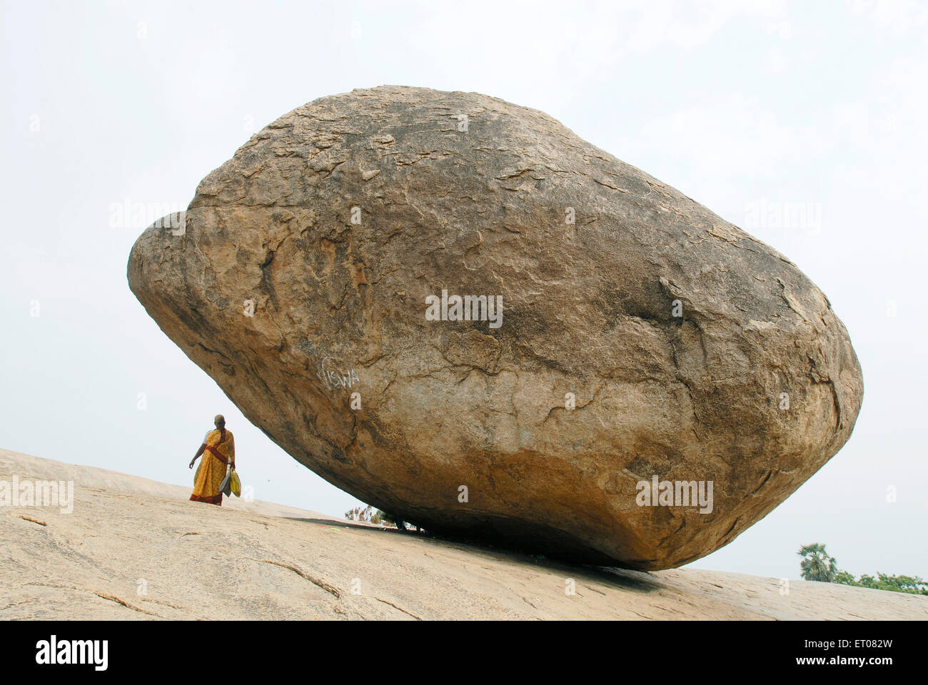 The huge granite boulder popularly known as Krishna's Butter Ball ; Mamallapuram ; Mahabalipuram ; Tamil Nadu ; India ; Asia Stock Photo