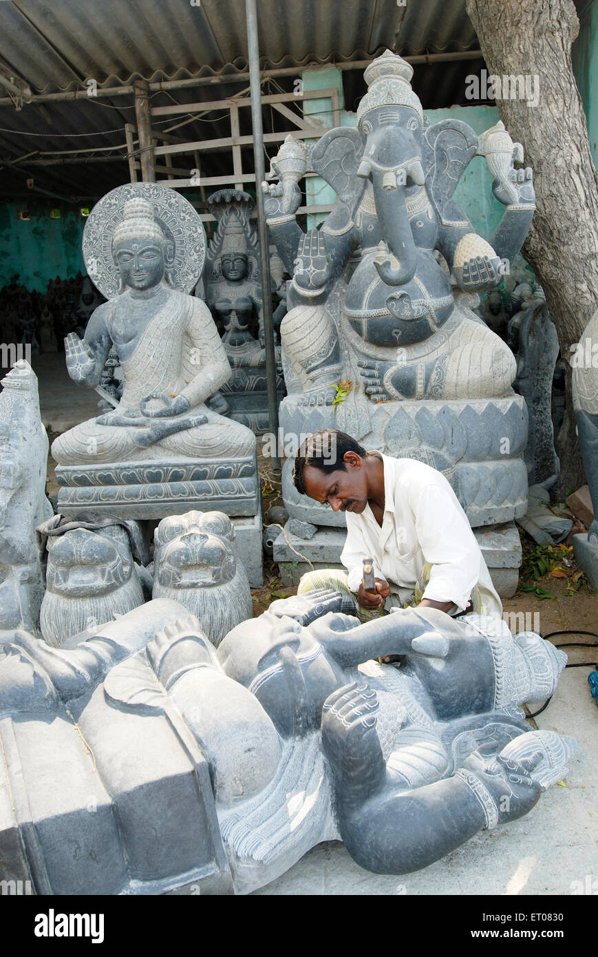 A sculptor making sculptures at Mahabalipuram ; Tamil Nadu ; India NO