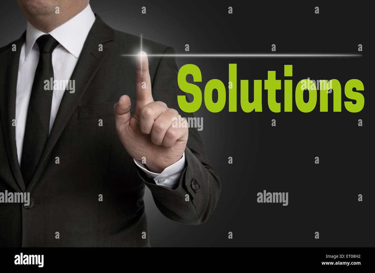 Solutions touchscreen is operated by businessman. Stock Photo