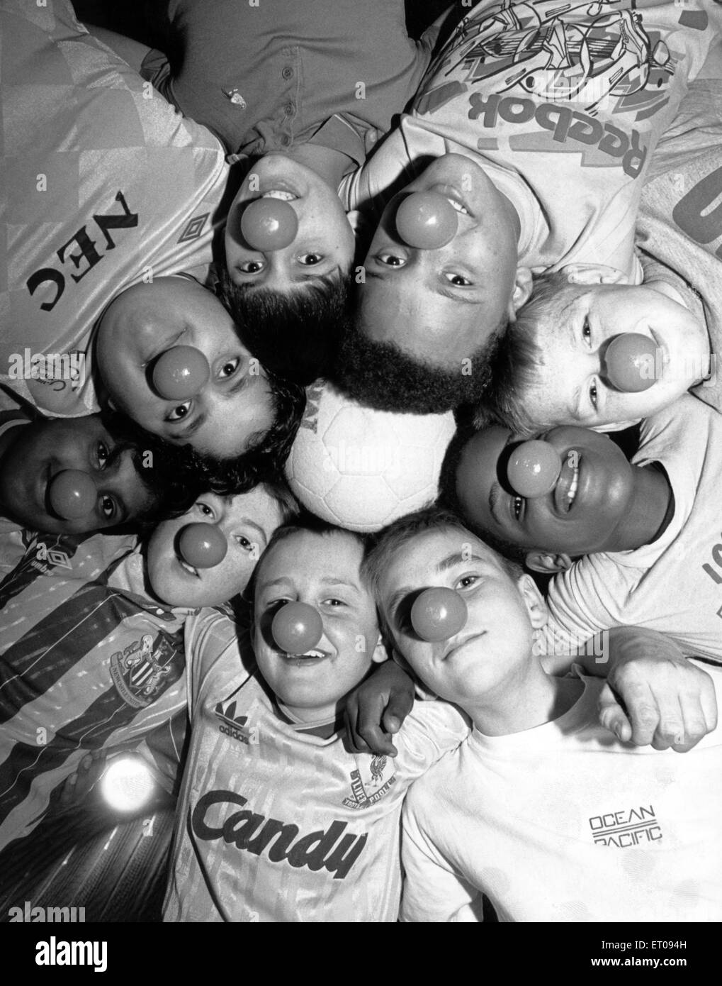 Teenagers Richard Parkinson, Andrew Thompson, Kalvinder Singh, Vikas Sharma, Nathan Jones, Constantine Katewu, Stuart Robson, adrian McKenzie and Raymond Morrison from Darlington kitted themselves out in football strips and red noses to raise money for Comic Relief. 9th March 1989. Stock Photo