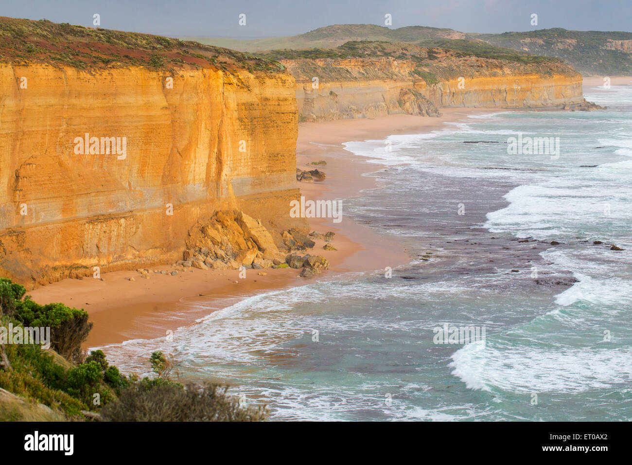 Rugged sandstone cliffs and rough waves near Port Campbell, Great Ocean Road, Victoria, Australia Stock Photo