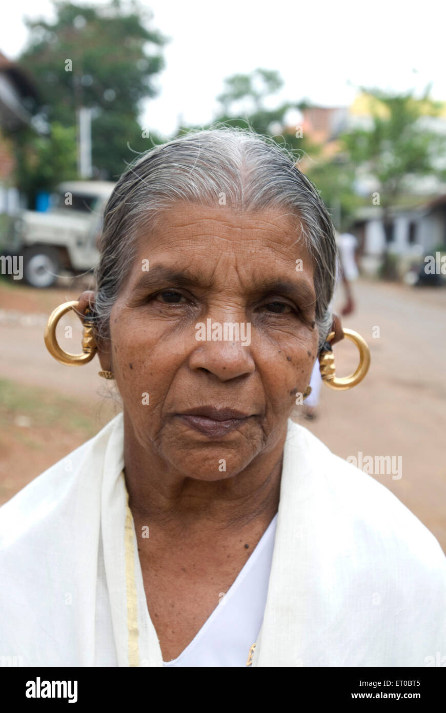 Kunukku, gold ear ring, ancient Christian Keralite jewelry, gold round earrings, worn by old traditional Syrian lady, Kerala, India, Asia Stock Photo