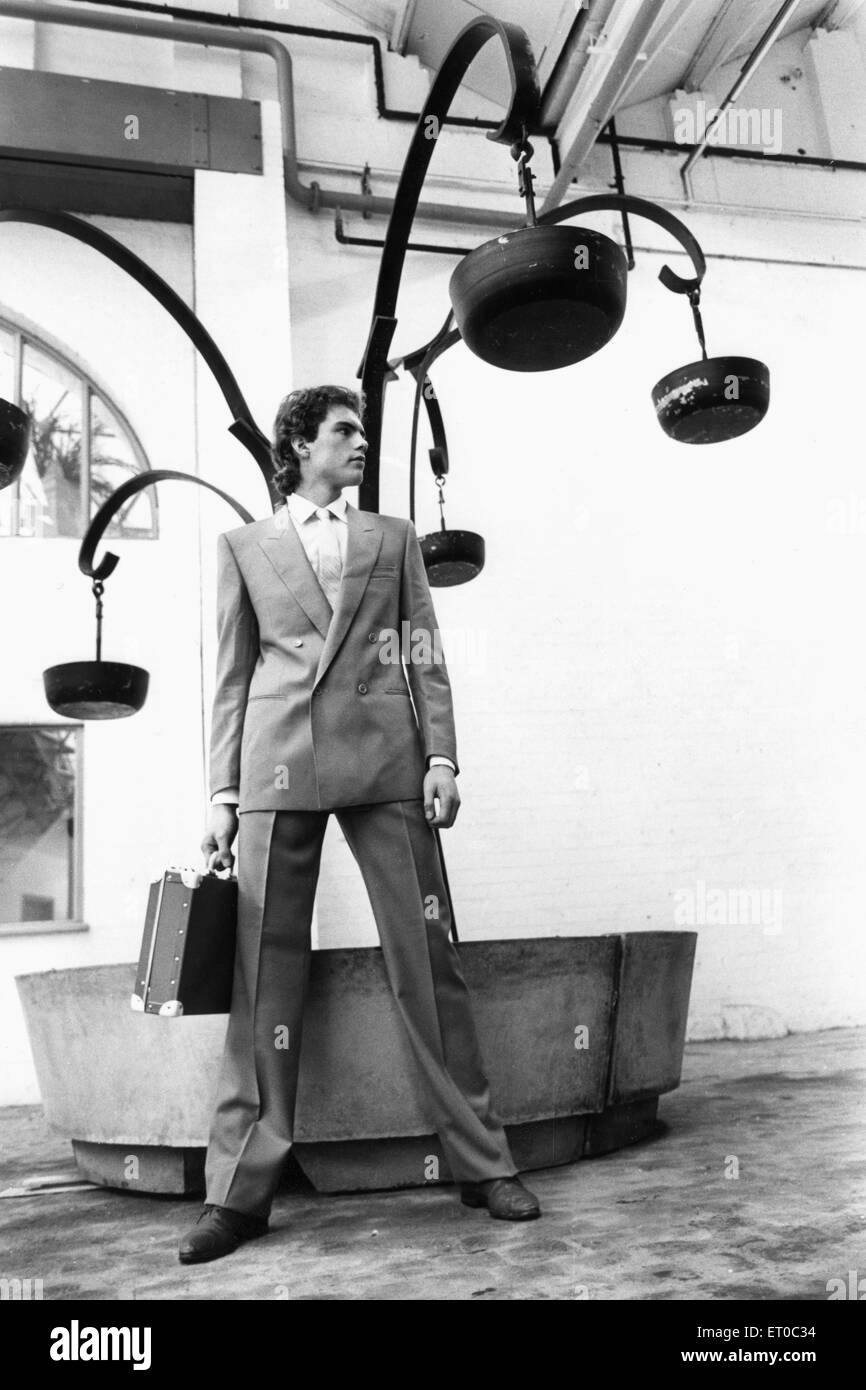 Mens Fashions Spring 1983. Our model wears Double breasted business suit carrying attache case. 25th April 1983 Stock Photo