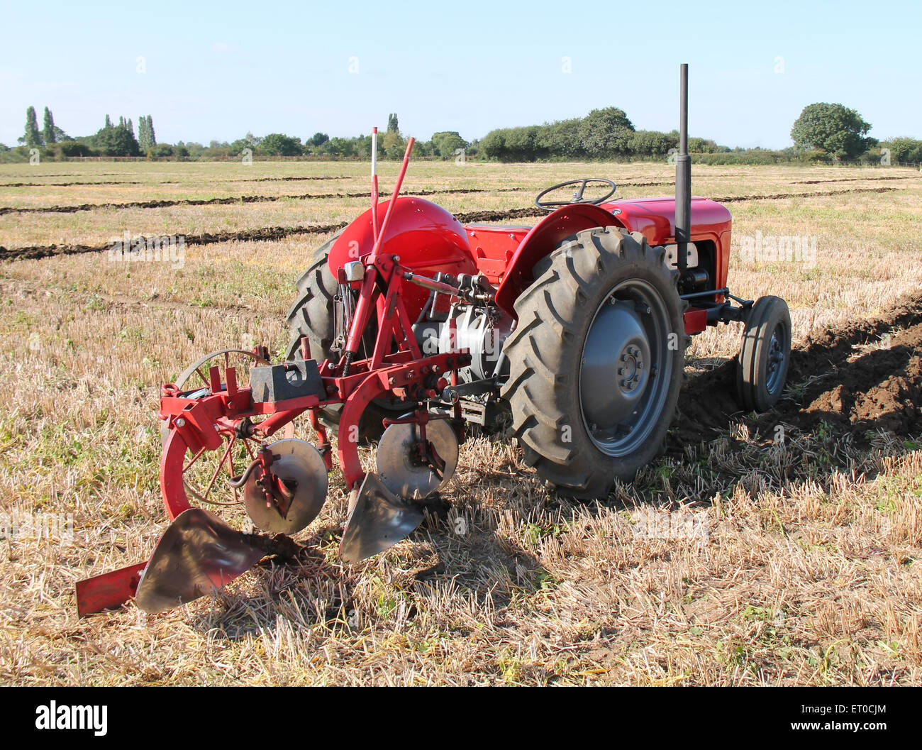 A Vintage Tractor and Plough Working on a Field Stock Photo Alamy
