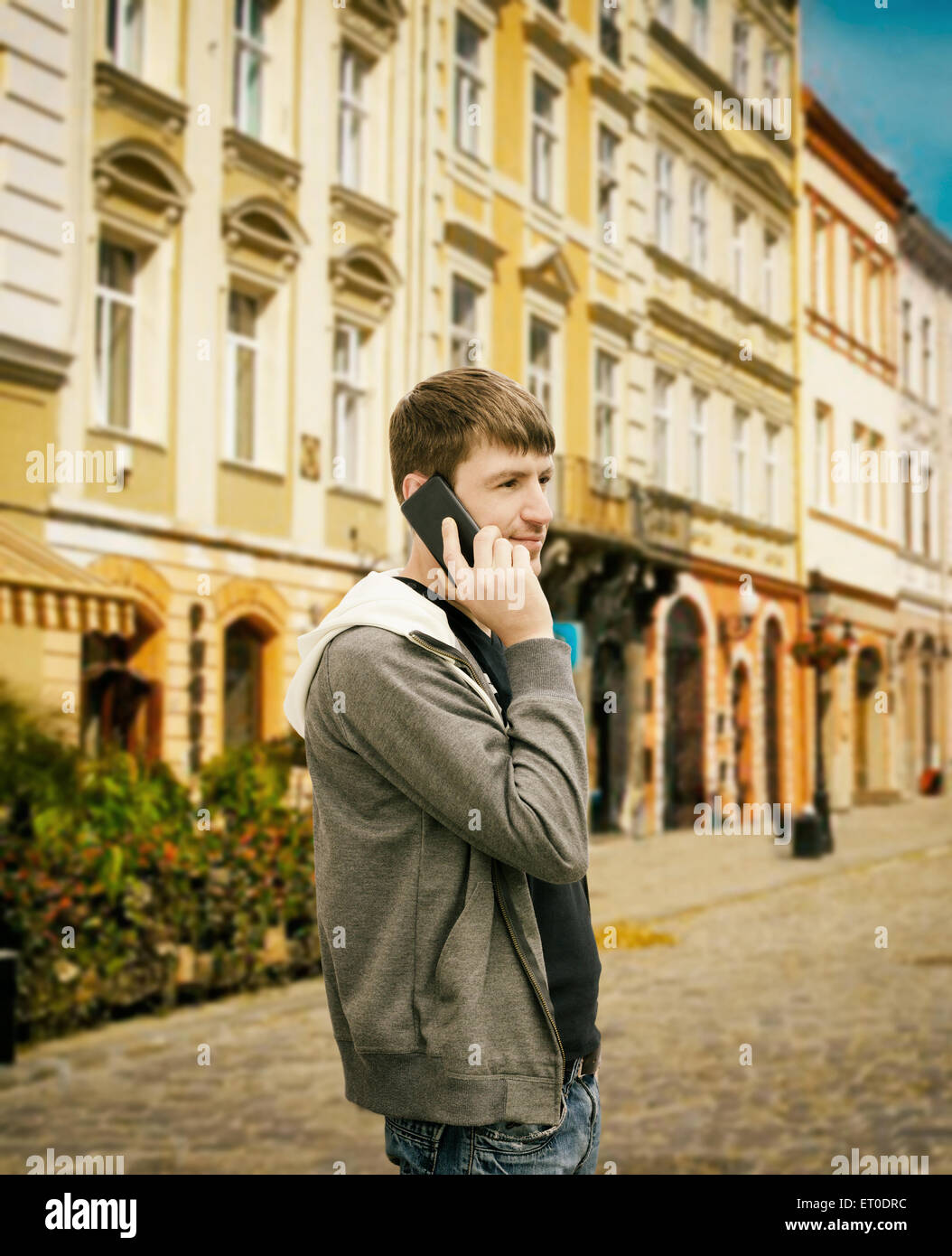 young man speaks by phone on the street Stock Photo