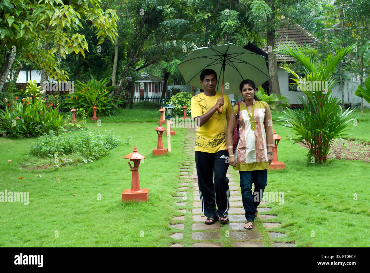 Couple enjoying monsoon in heritage lake resort ; Kuttanad ; Alleppey Alappuzha ; Kerala ; India MR#777K;777L Stock Photo