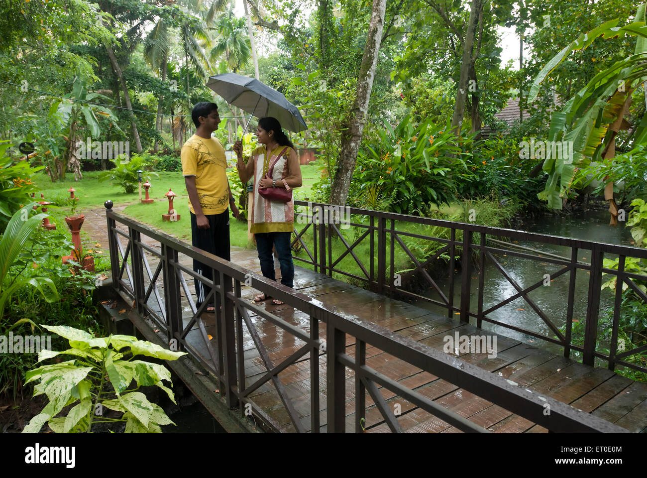 Couple enjoying monsoon in heritage lake resort ; Kuttanad ; Alleppey Alappuzha ; Kerala ; India MR#777K;777L Stock Photo