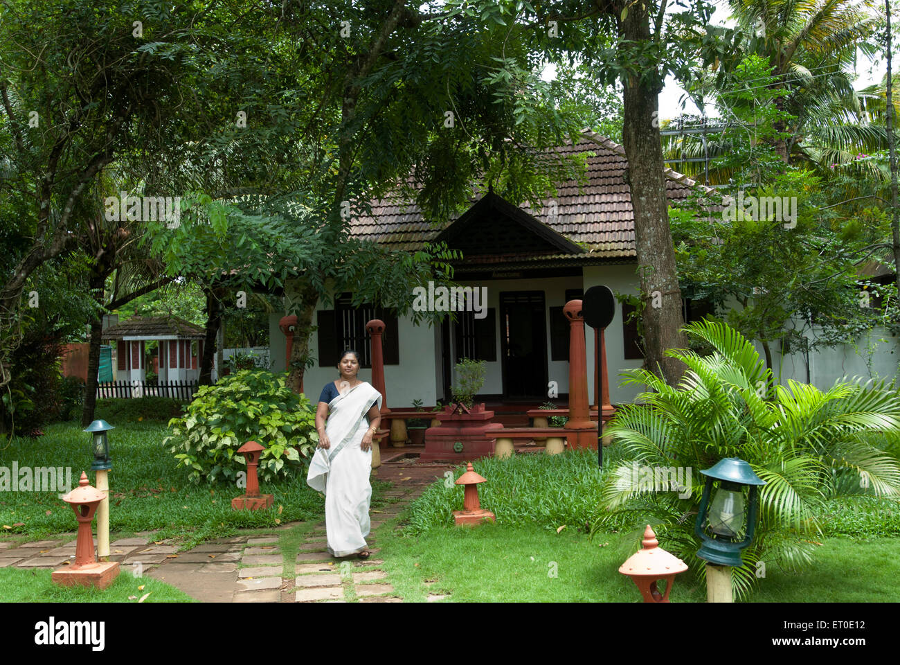 Woman in front of house ; Alleppey Alappuzha ; Kerala ; India NO MR Stock Photo