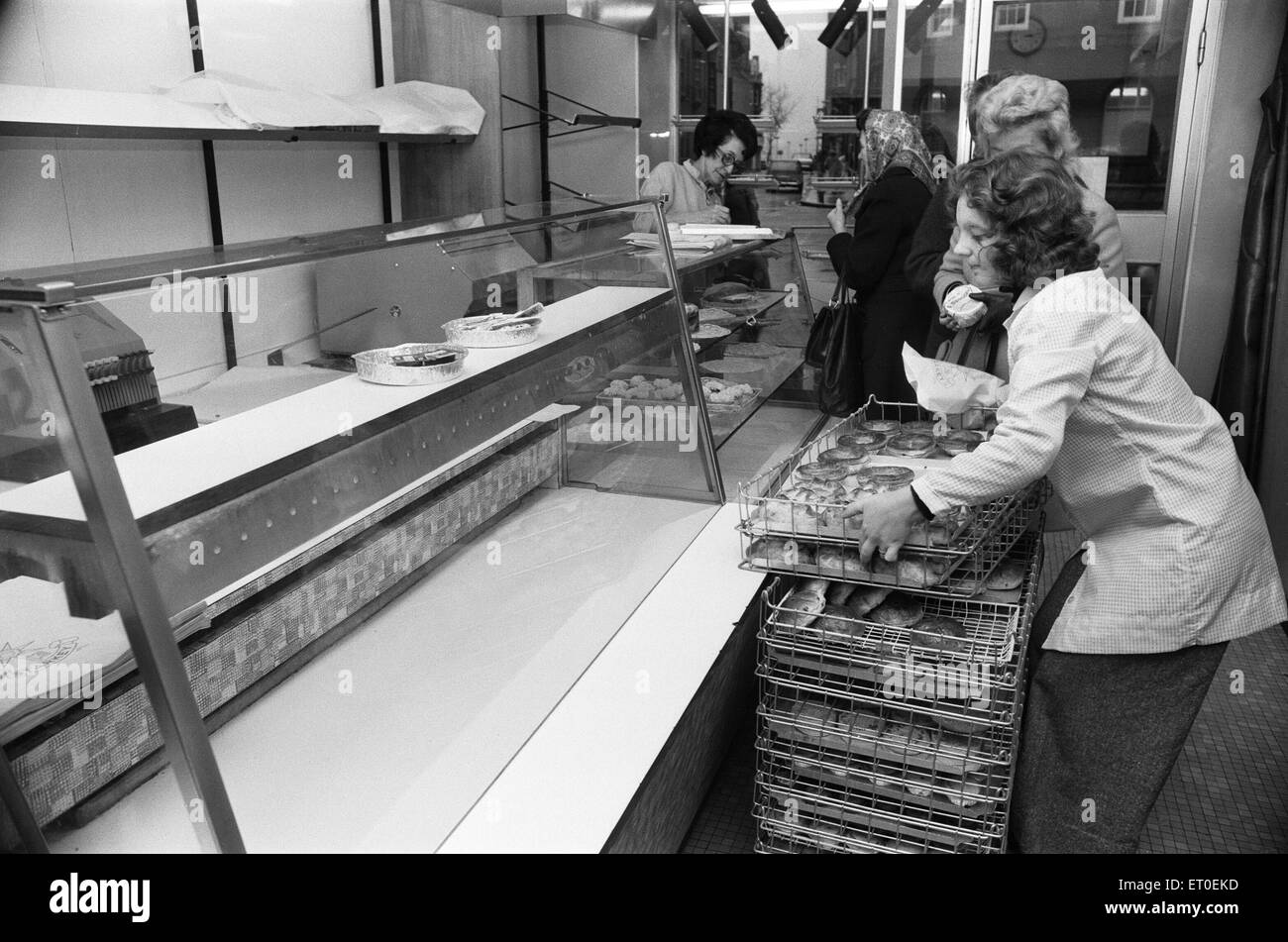 THE SEVENTIES were a time of strikes and, in December 1974, the big national bakers decided to follow suit, demanding a 66% pay rise. Staff of larger firms had empty shelves and had to turn away dozens of customers. Small bakeries were working full-out but were unable to meet the demand as shops phoned in for extra supplies. Yeast sales went up as housewives decided to bake their own bread. (Picture) Empty shelves in bakery. 3rd December 1974 Stock Photo