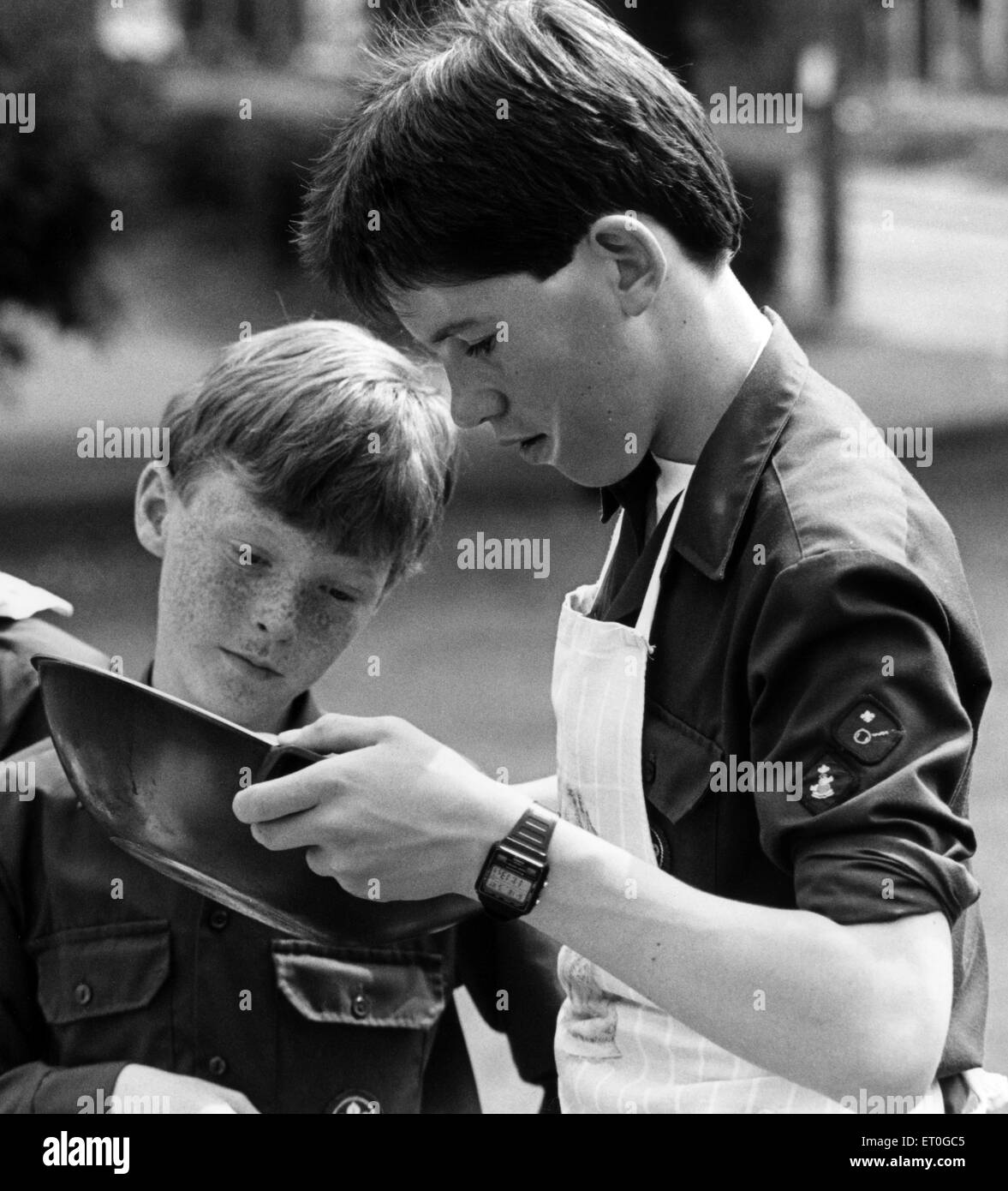 Boys Scouts pictured during cooking competition in Guisborough, Redcar and Cleveland, North Yorkshire, 18th June 1988. Christopher Ritchie and Graeme Williams of the 5th Guisborough make sure the mixture is not too thick. Stock Photo