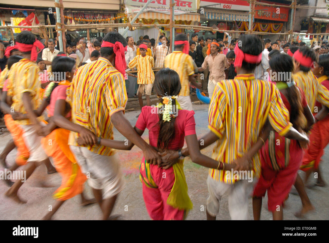 Twenty Men and women forming circle doing tribal dance at Navaratri festival ; Dadar ; Bombay Mumbai ; Maharashtra Stock Photo