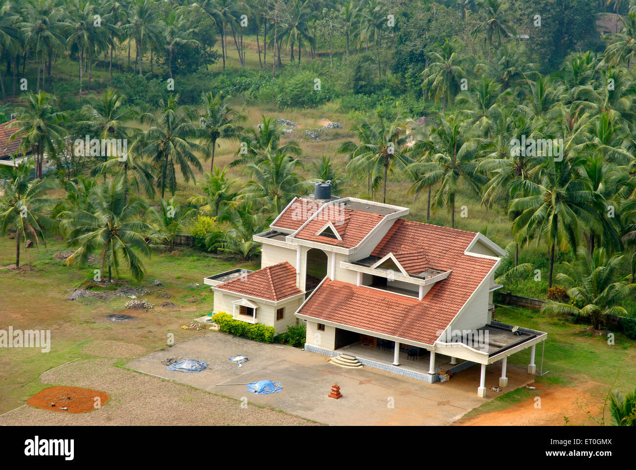 Aerial view of bungalow surrounded by coconut trees ; Karkal district ; Mangalore ; South Kanara ; Karnataka ; India Stock Photo