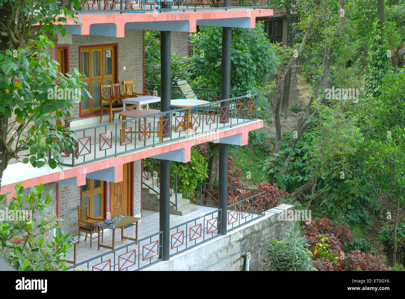Two balconies of tourist resort with tables and chairs at Madikeri Madikery ; District Coorg ; Karnataka ; India Stock Photo