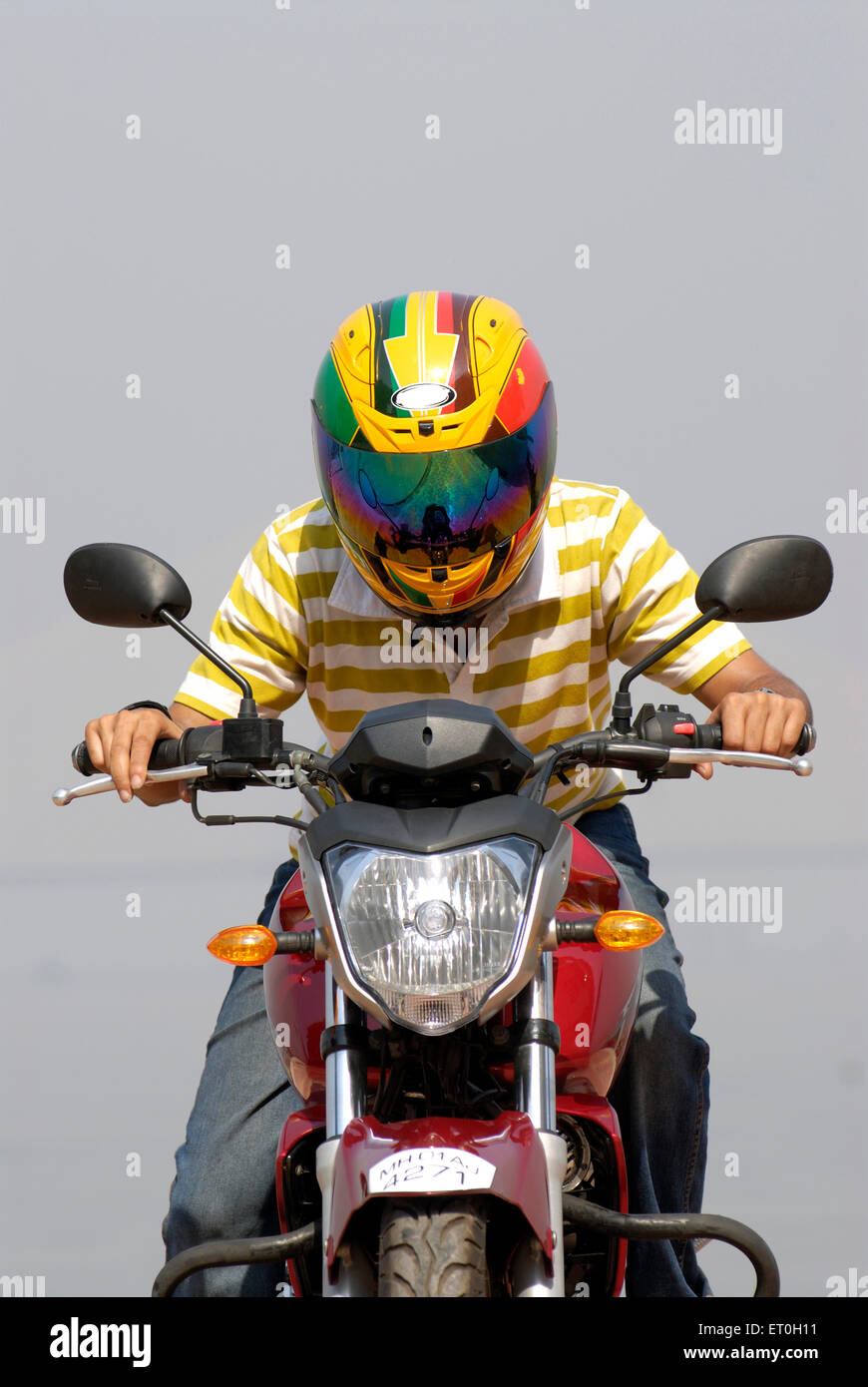 Young boy in helmet riding red coloured yamaha fz motorcycle 150cc bike ; Bombay Mumbai ; Maharashtra ; India MR#721 Stock Photo