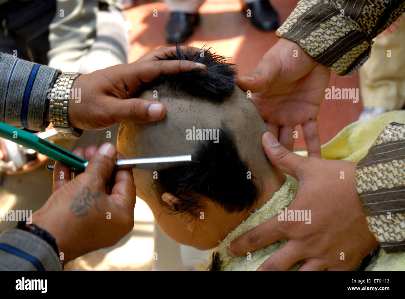 Mundan ceremony, Chudakarana ceremony, Mundana ceremony, tonsure haircut, thread ceremony of five year old boy, India, Asia,  MR#721 Stock Photo