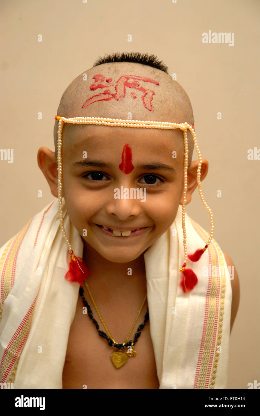 Bald headed eight year old Indian boy thread ceremony India - Model Release #721 Stock Photo