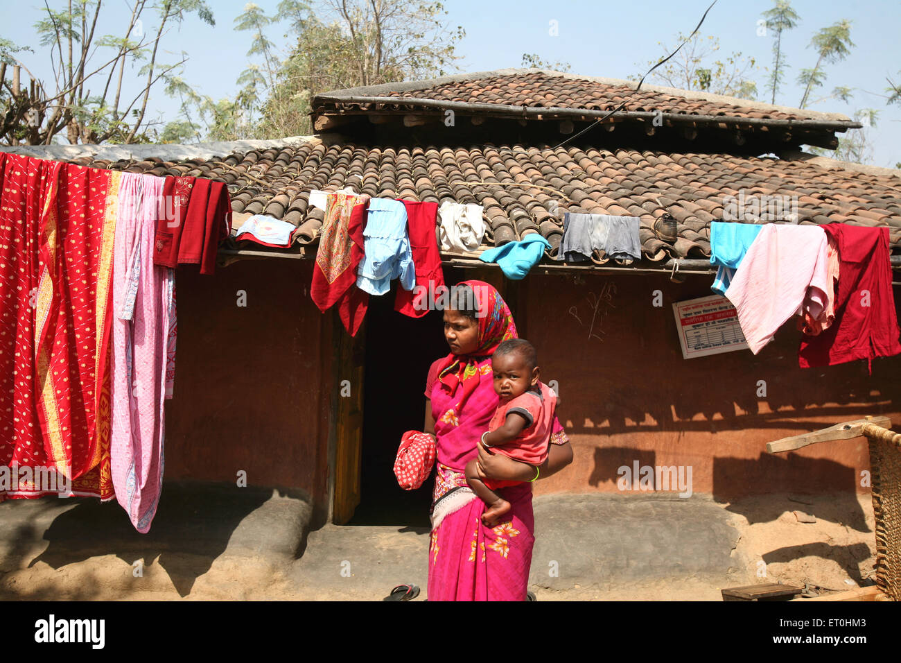 Indian rural woman carrying baby on village road, Ranchi, Jharkhand, India, Indian life Stock Photo