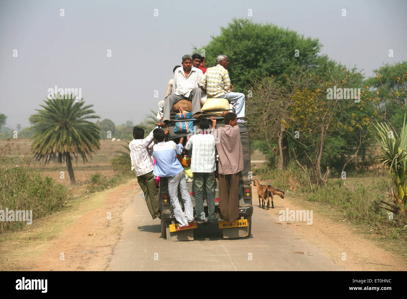 Passengers sitting on top of jeep used as local transport in Jharkhand India Stock Photo