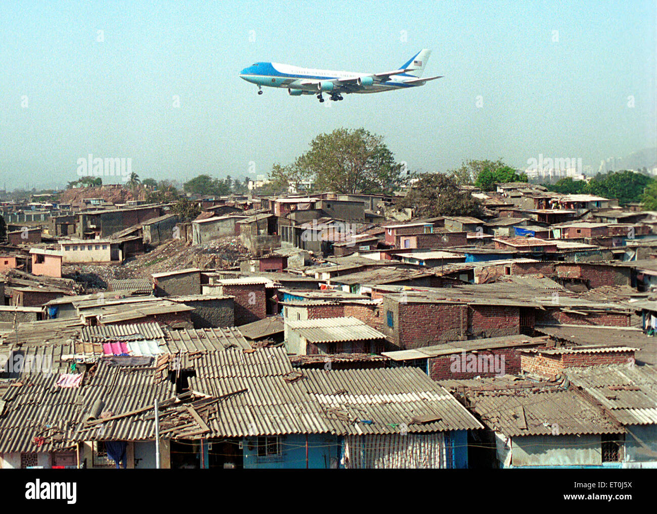 Air force one official carrier American President flying over slums Chattrapati Shivaji International airport in Bombay Mumbai India - mpd 153869 Stock Photo