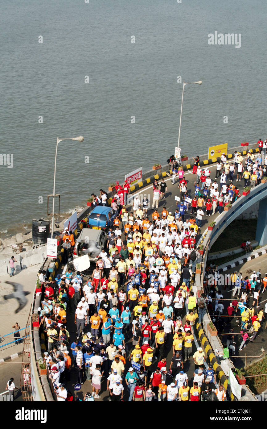 Participants running on Charni road flyover at the Queen's Necklace in Nariman Point ; Mumbai marathon event organized Mumbai Stock Photo