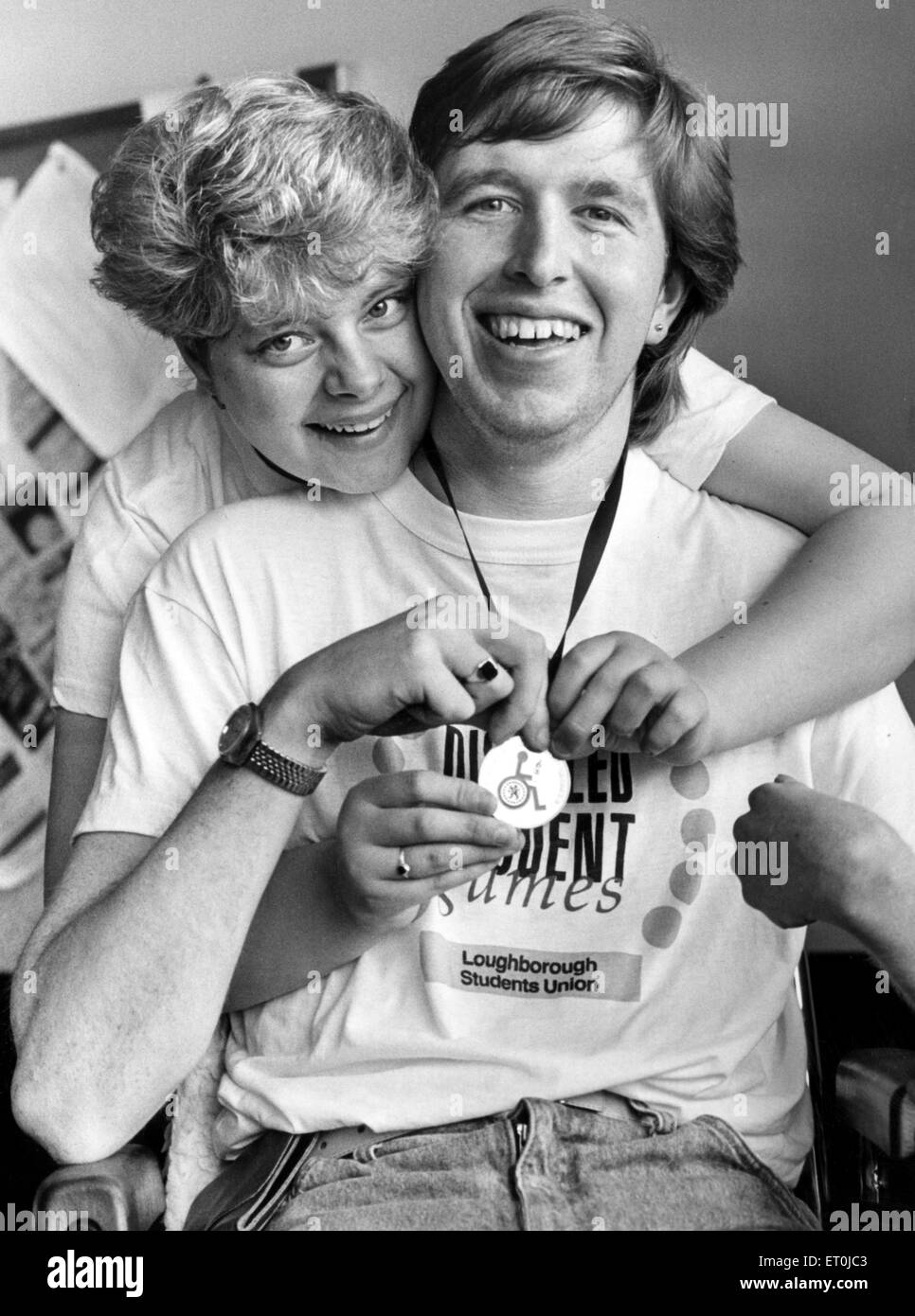 Dave Yewlett, who was in a near-fatal road accident three years ago, and went on to win sporting medals despite being wheelchair-bound. Dave being congratulated by his 18 year old girlfriend Dionne Young, for winning a silver medal at the Disabled Games held in Loughborough. 23rd April 1988. Stock Photo