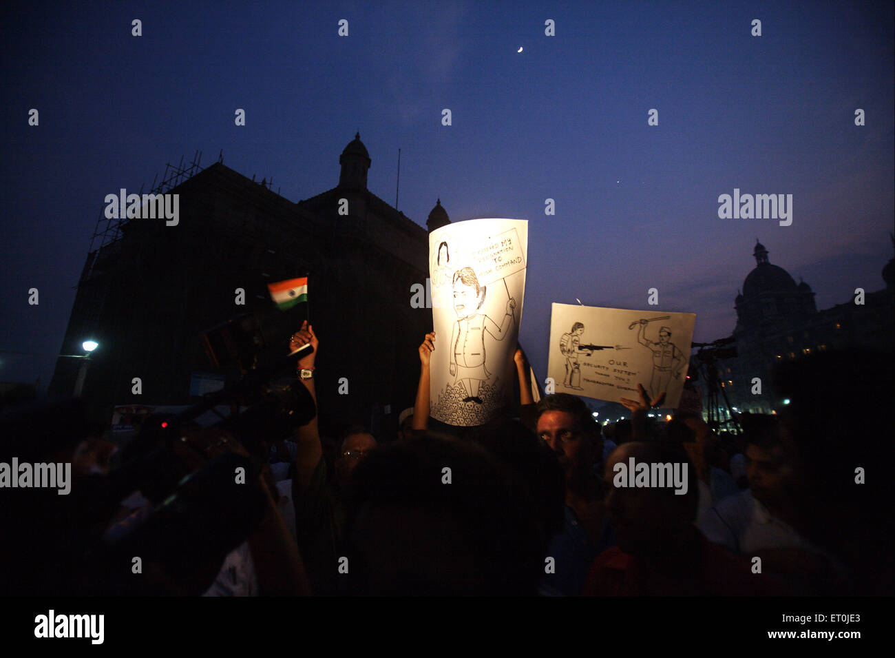 People holding placard cartoons chief minister Maharashtra Vilasrao Deshmukh protest terrorist attack 26th November 2008 Bombay Stock Photo