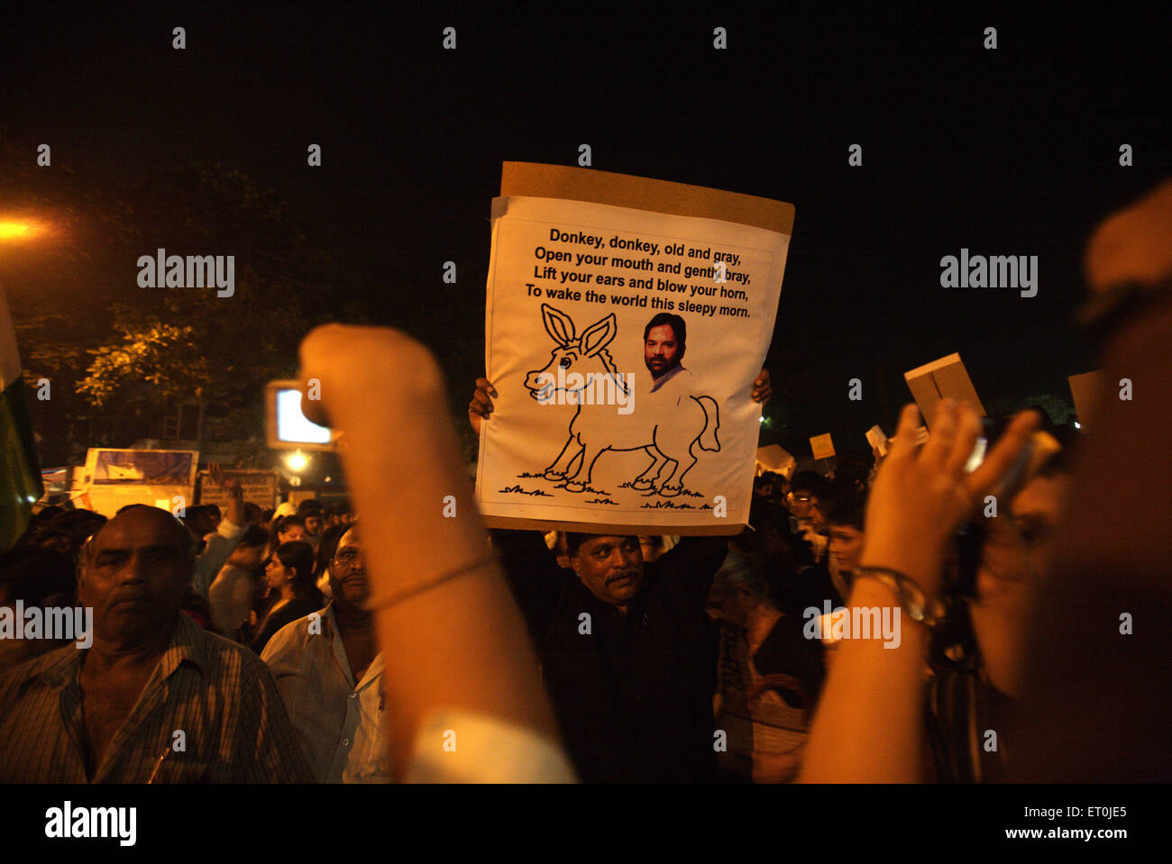 People holding placard cartoons senior BJP leader Naqvi sitting donkey mass protest terrorist attack 26th November 2008 Bombay Stock Photo