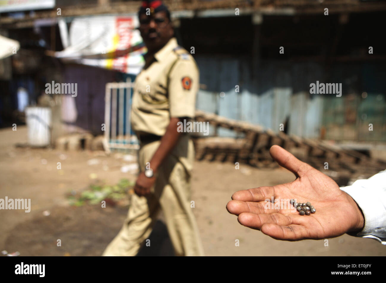 Man displaying the dismantled parts of the bomb found at the site of bomb blast which rocked textile town of Malegaon Stock Photo