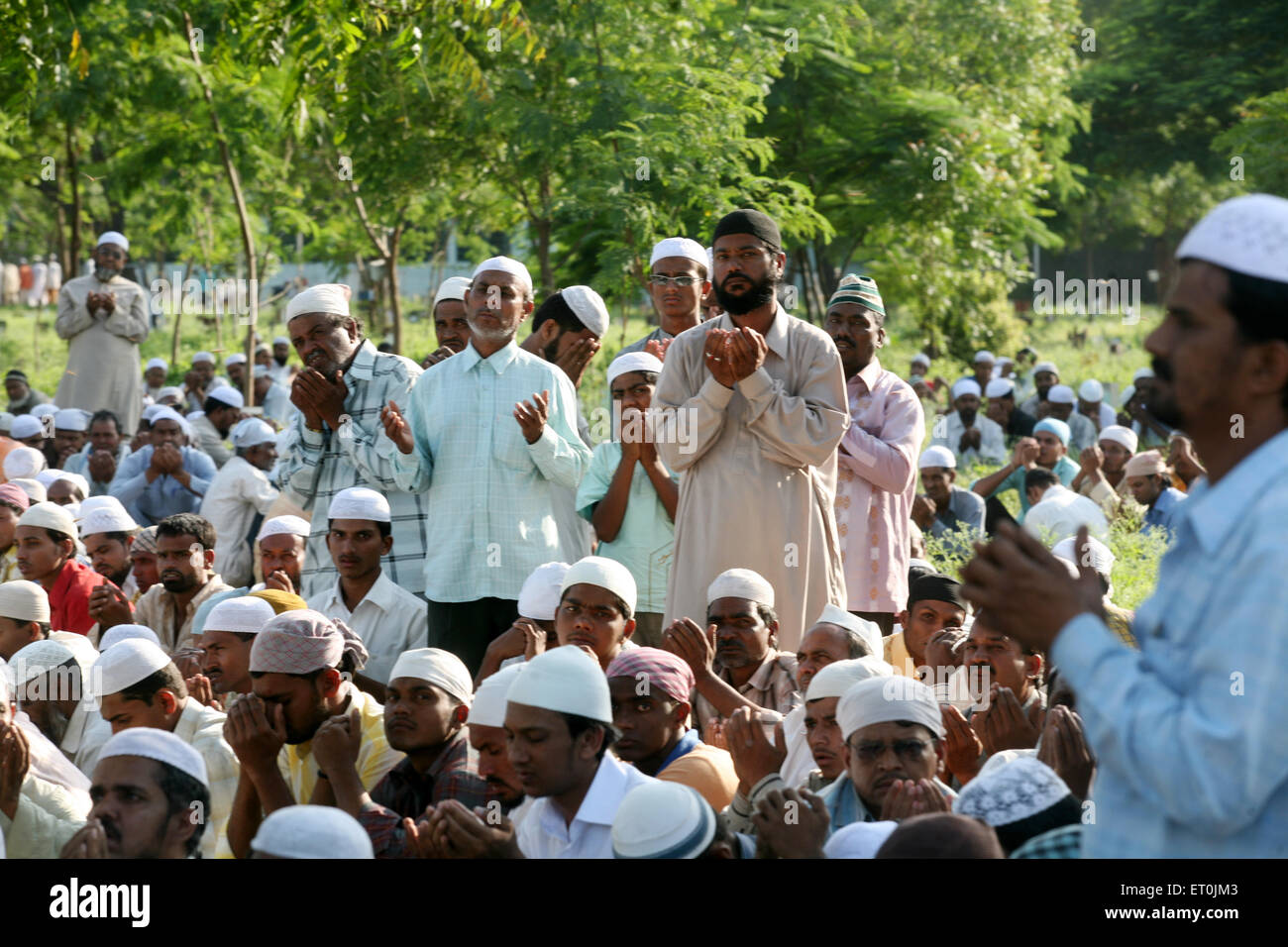 People praying during burial of their family members who died in powerful bomb blast on 29th September 2008 at Malegaon Stock Photo