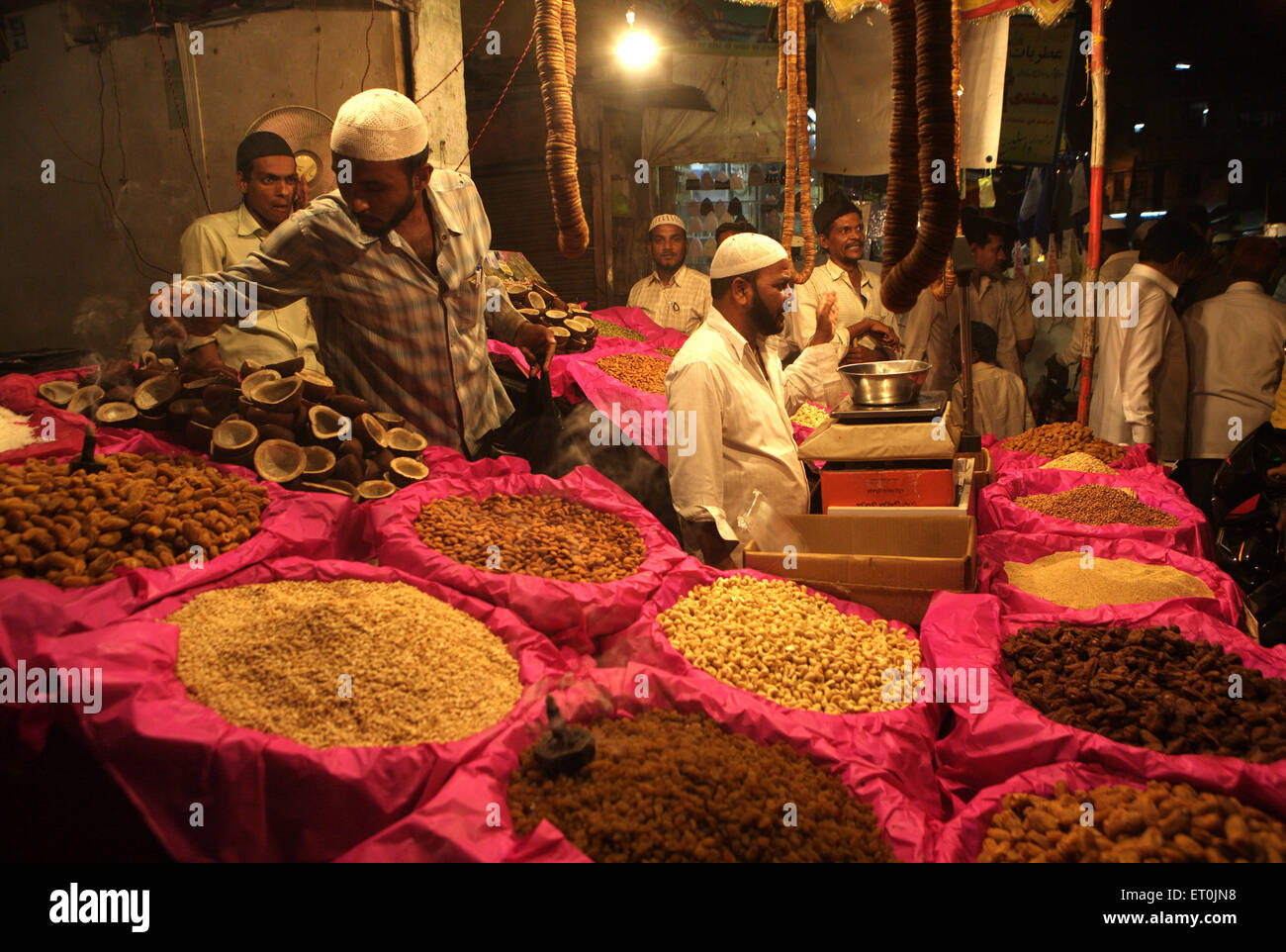 A dry fruit merchant shop at the local market of Malegaon ; Maharashtra ; India Stock Photo