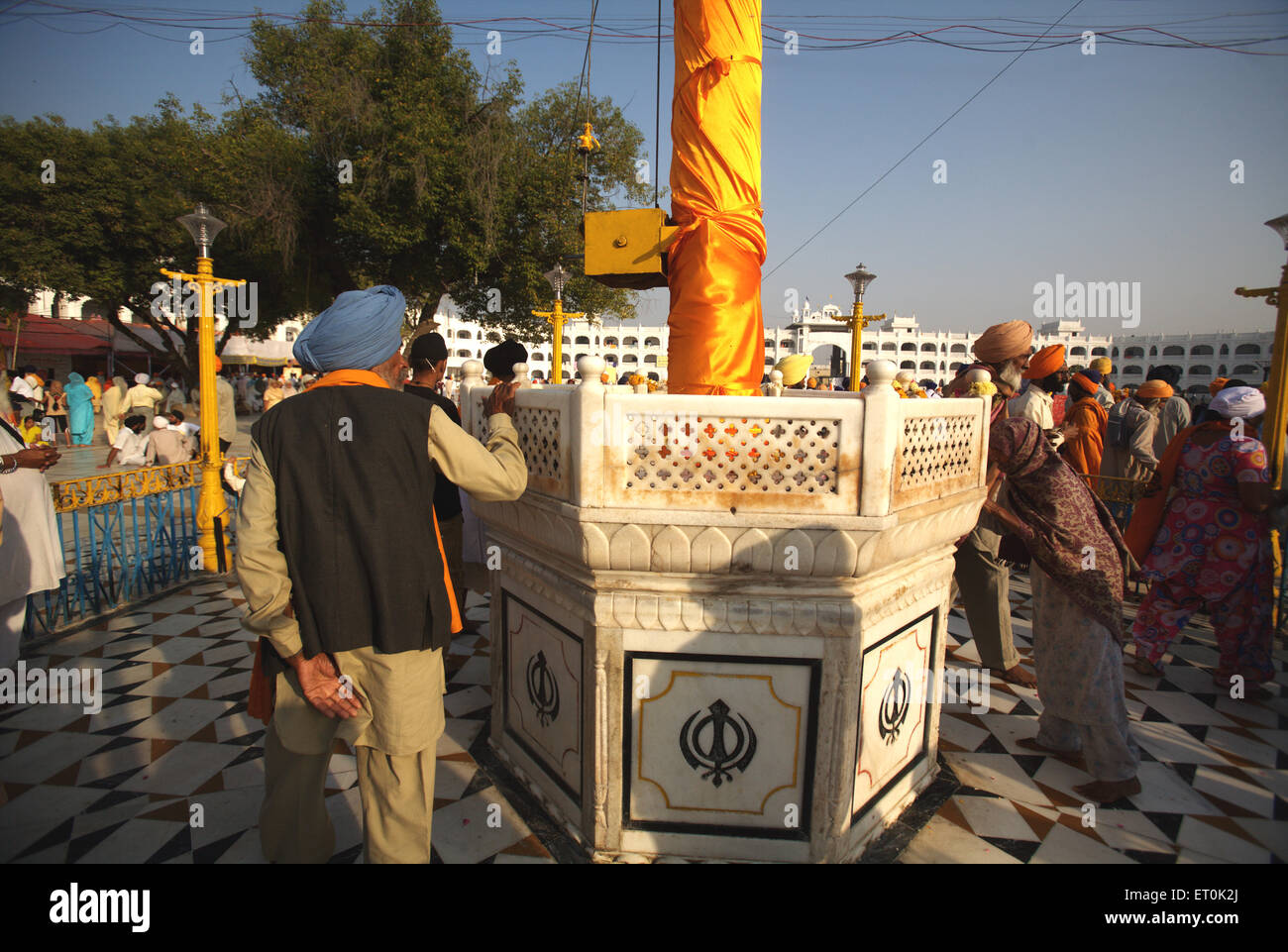 Sikh devotee paying his respect to Nishansahib compound of Sachkhand Saheb Gurudwara ; Nanded Stock Photo