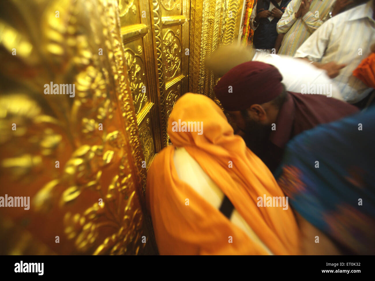Sikh paying respects at golden doors ; consecration of perpetual Guru Granth Sahib; Sachkhand Saheb Gurudwara in Nanded Stock Photo