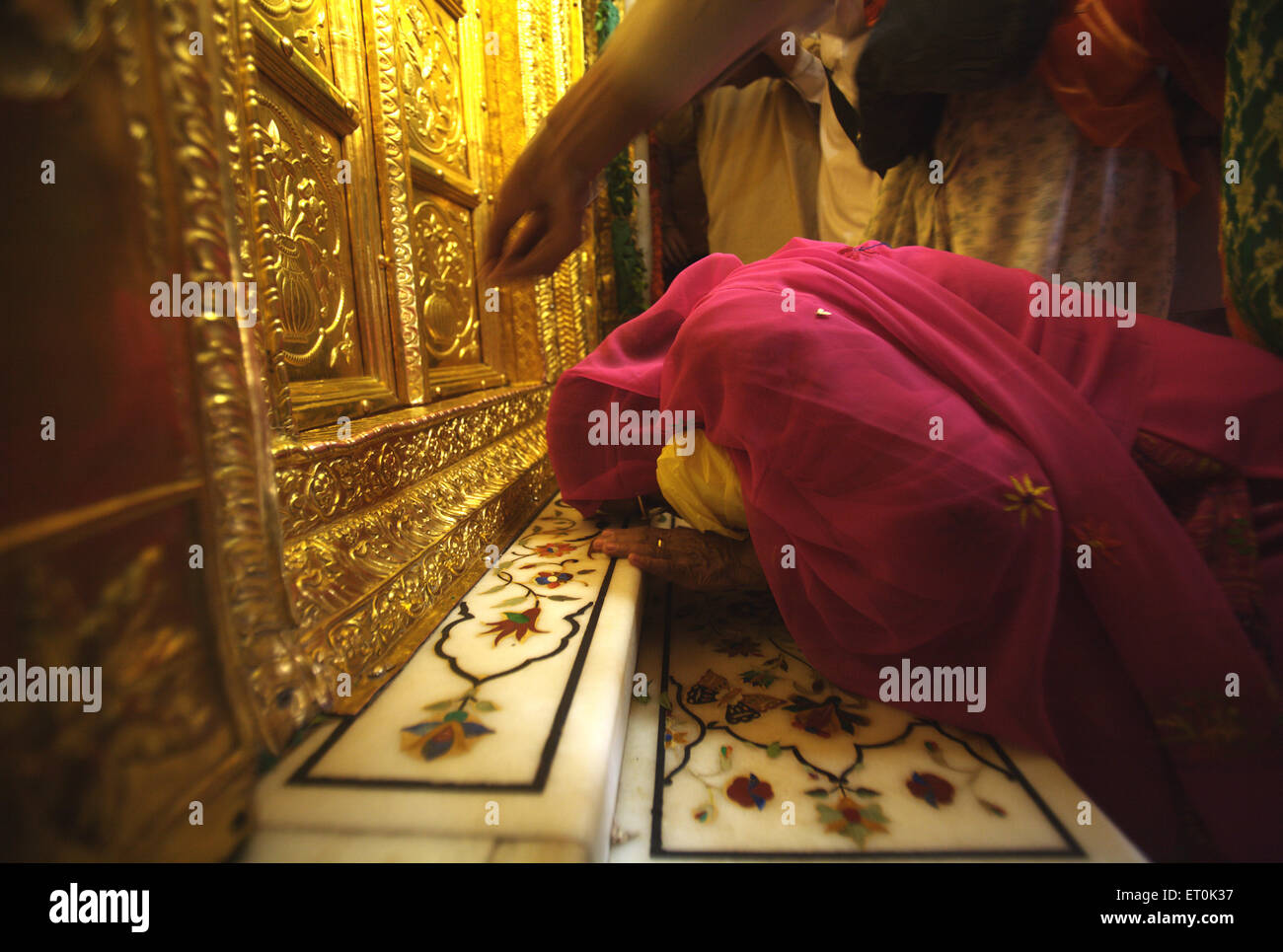 Sikh paying respects golden doors ; celebrations consecration perpetual Guru Granth Sahib; Sachkhand Saheb Gurudwara in Nanded Stock Photo