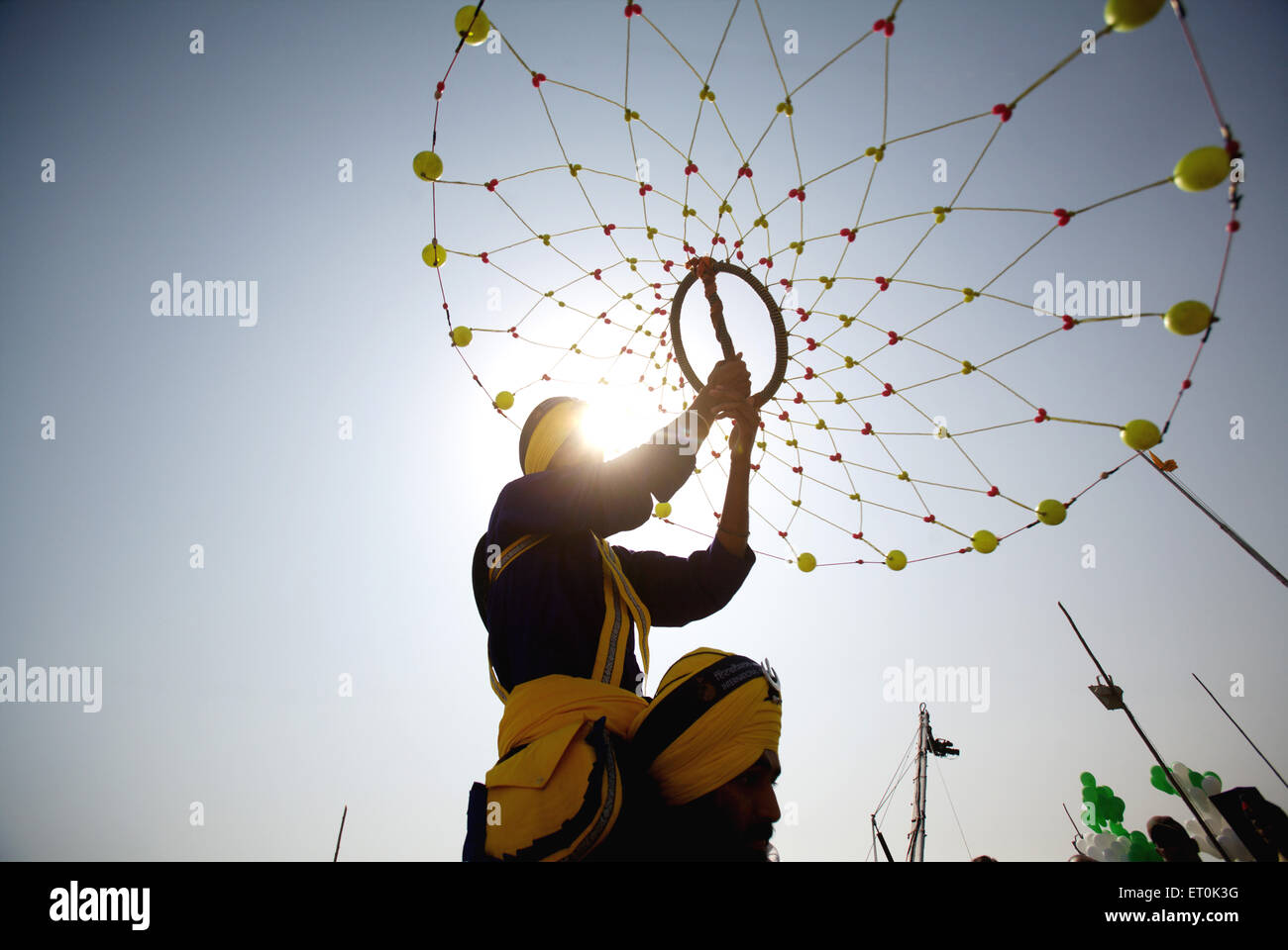 Young Nihang Sikh warrior performing traditional martial art Gatka consecration perpetual Guru Granth Sahib Nanded Marathwada Maharashtra India Indian Stock Photo